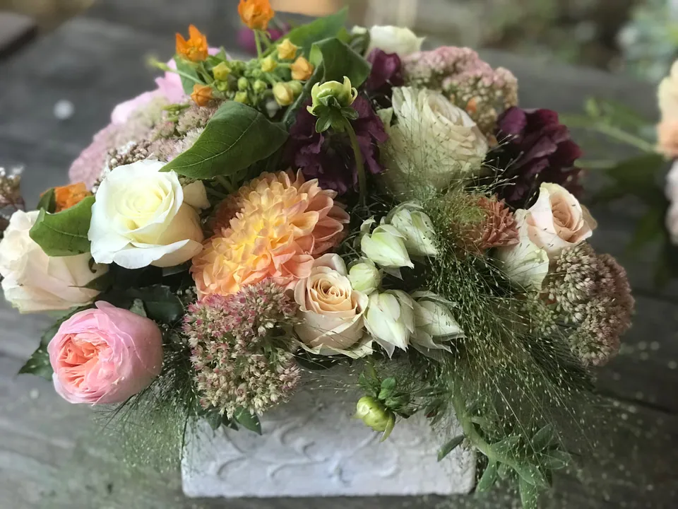Low garden style arrangement with roses, pale hydrangea, and garden texture by Margaret Rose Floral Design in Long Beach.